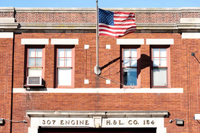 Flag flies outside FDNY Firehouse, Engine 307, Ladder 154, in New York, November Thousands of New York City firefighters have called out sick in an apparent protest over the requirement,